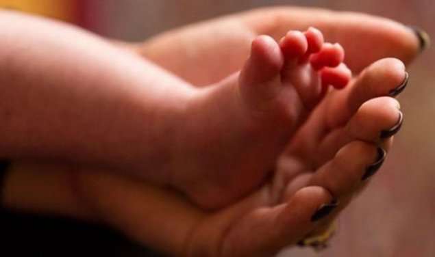 Babies feet in mothers arms