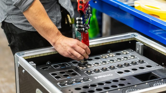 A close up photograph of someone creating a live streaming rack. Used for professional digital events.